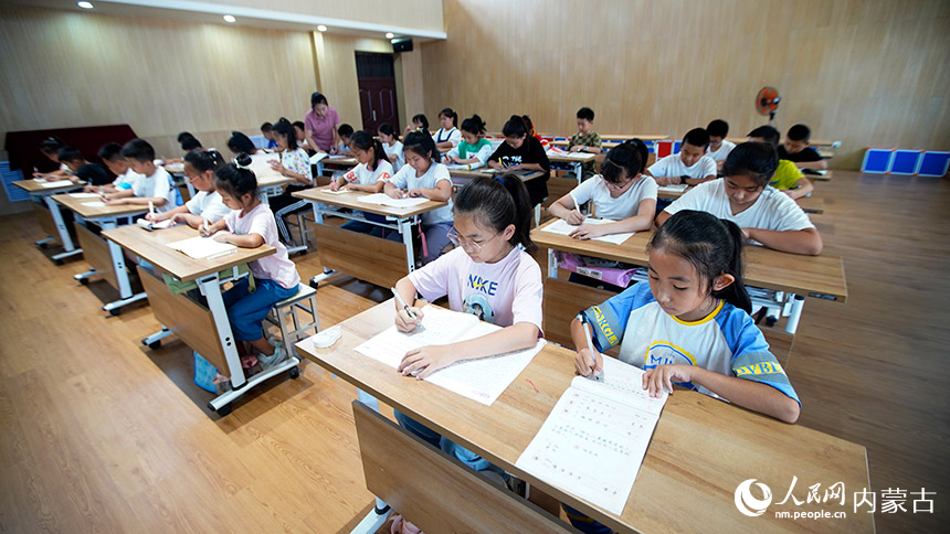 作業輔導中，孩子們十分安靜地認真完成暑假作業。李強攝