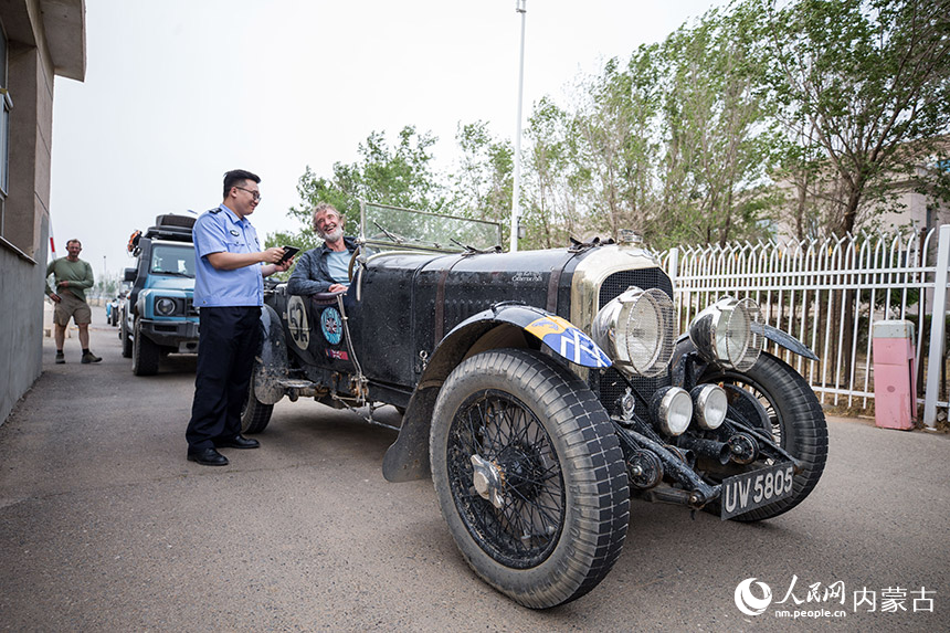 二連出入境邊防檢查站移民管理警察為自駕旅游團辦理入境通關手續。郭鵬杰攝