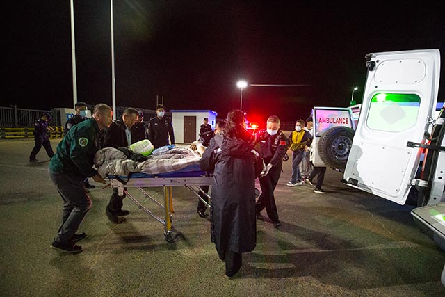 二連出入境邊防檢查站移民管理警察協助救護人員，將患者轉移至中方救護車。