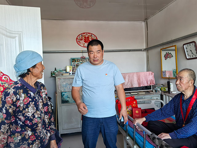 圖為9月12日,內(nèi)蒙古化德縣崩巴圖村黨支部書記李國(guó)成(圖中)慰問看望78歲的老黨員侯佃祥一家。記者 張棖攝