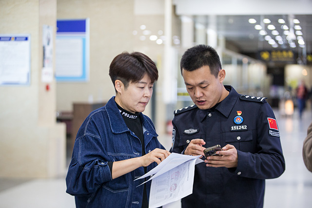 圖2：2024年10月31日，二連出入境邊防檢查站民警為旅行社負(fù)責(zé)人介紹“邊檢通”備案預(yù)約服務(wù)平臺功能。