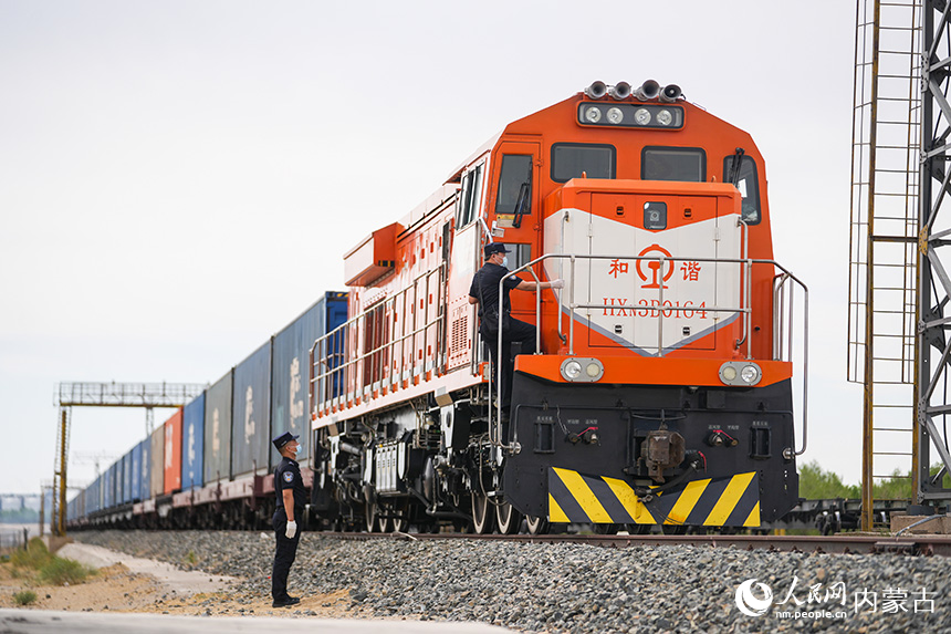 2024年5月27日,二連出入境邊防檢查站執移民管理警察對出境中歐班列進行車體檢查。郭鵬杰攝