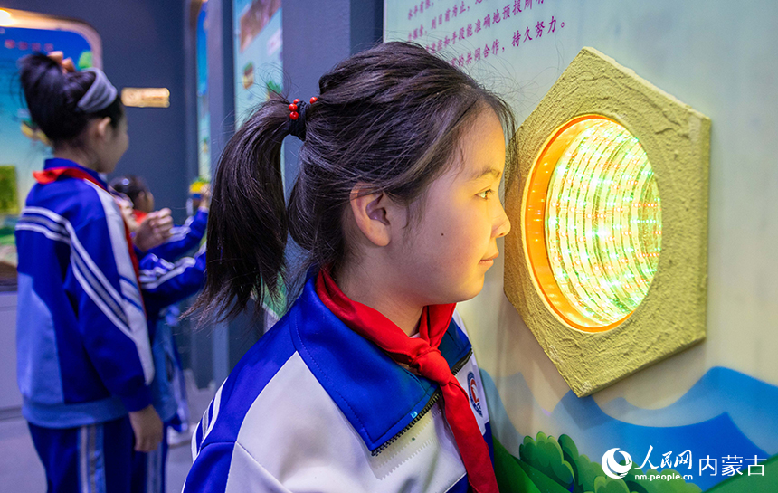 內蒙古呼和浩特市玉泉區通順街小學學生在地震科普館里通過模型了解地震前兆知識。丁根厚攝