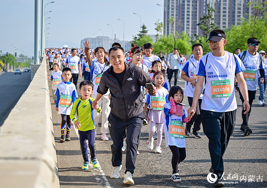 賽事現(xiàn)場，參賽家庭攜手奔跑。實習(xí)生 賈志紅攝