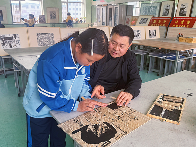 李范義到科左中旗蒙古族實驗學校指導學生版畫作品。包烏蘭攝