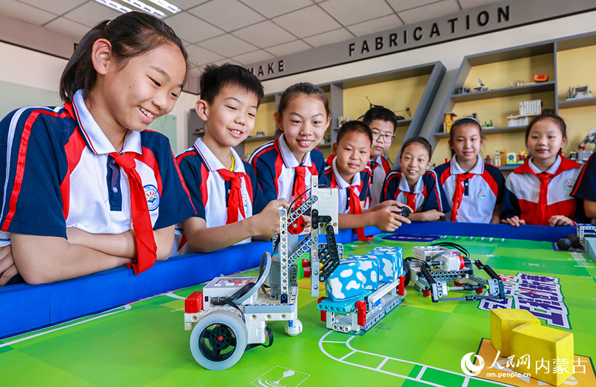 呼和浩特市玉泉區石東路小學學生在學習調試編程機器人。丁根厚攝