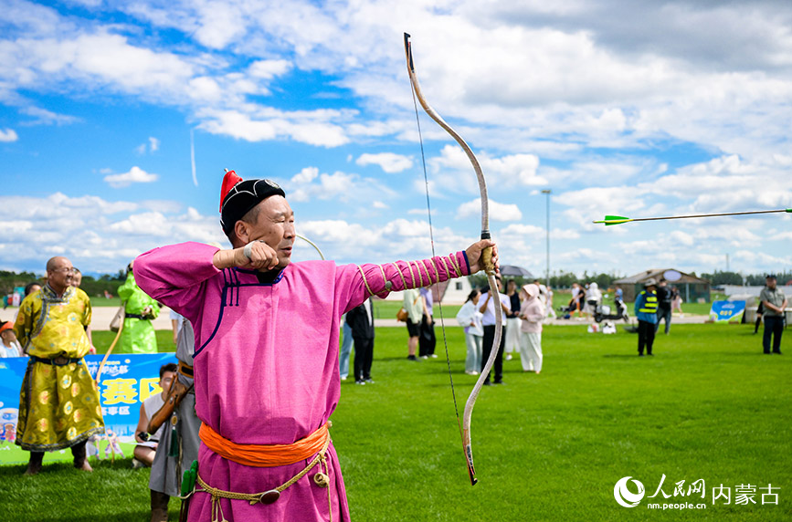 7月5日，游客在呼和浩特城市那達(dá)慕活動現(xiàn)場觀看射箭比賽。丁根厚攝