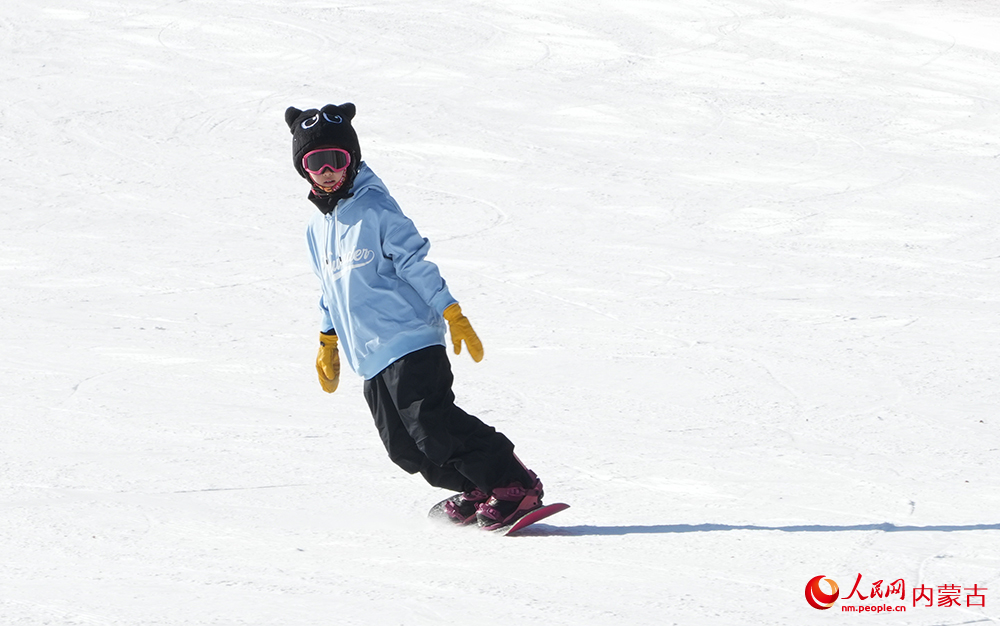 愛好滑雪運(yùn)動(dòng)的小朋友在練習(xí)單板滑雪。人民網(wǎng)記者 張雪冬攝