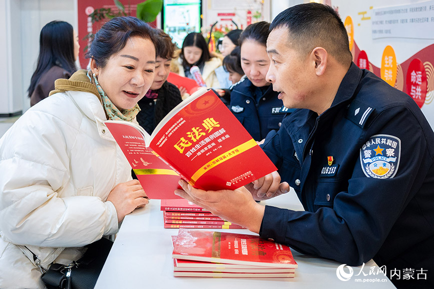 12月4日，呼和浩特市玉泉區公安分局興隆巷派出所民警為清泉街社區居民講解民法典知識。丁根厚攝